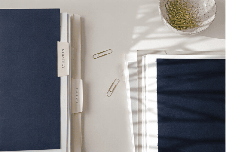 Folders labelled Strategy and Budget on a desk, representing home loan structure and repayment planning
